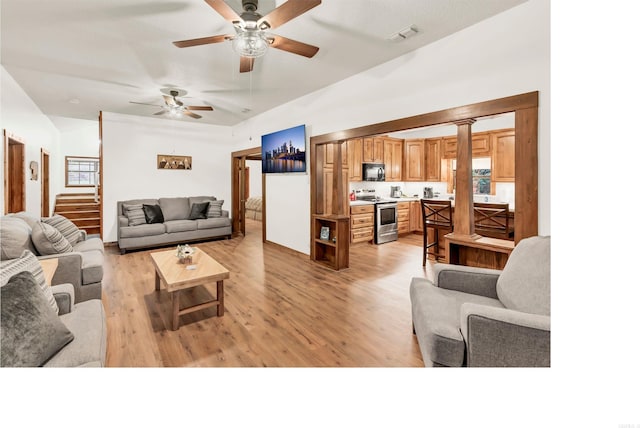 190 Polk Road 624, Mena, AR 71953 - living room featuring light wood-style floors, stairway, a ceiling fan, and vaulted ceiling