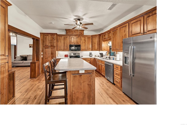190 Polk Road 624, Mena, AR 71953 - kitchen with light countertops, appliances with stainless steel finishes, ceiling fan, and light wood-style flooring