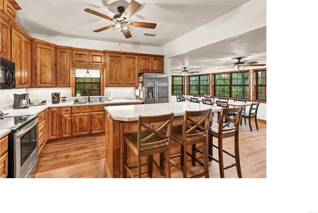 190 Polk Road 624, Mena, AR 71953 - kitchen with a sink, light wood finished floors, appliances with stainless steel finishes, and ceiling fan