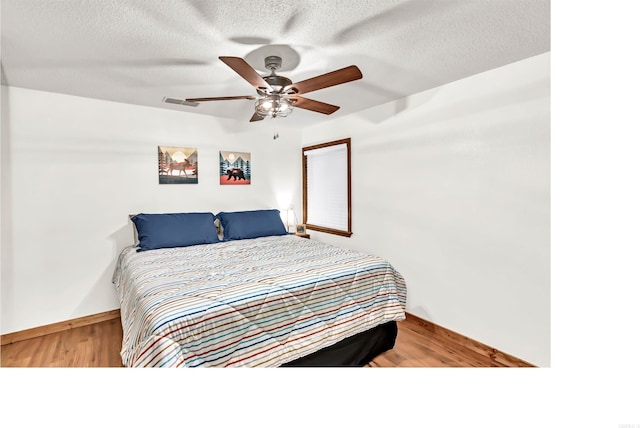 190 Polk Road 624, Mena, AR 71953 - bedroom with visible vents, a textured ceiling, light wood-style floors, and baseboards