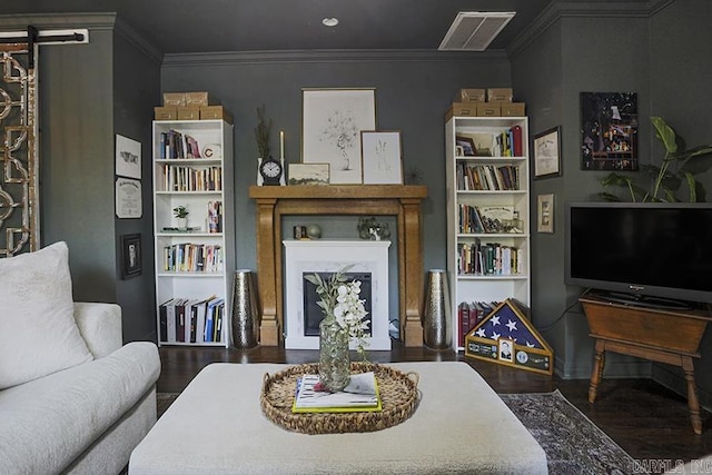 living room featuring crown molding, wood finished floors, and visible vents