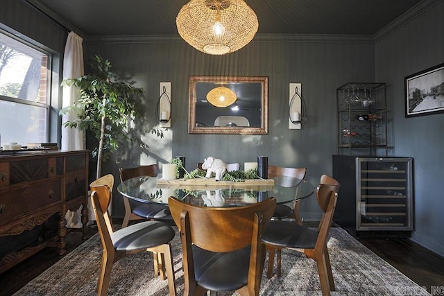 dining area with beverage cooler, ornamental molding, baseboards, and wood finished floors