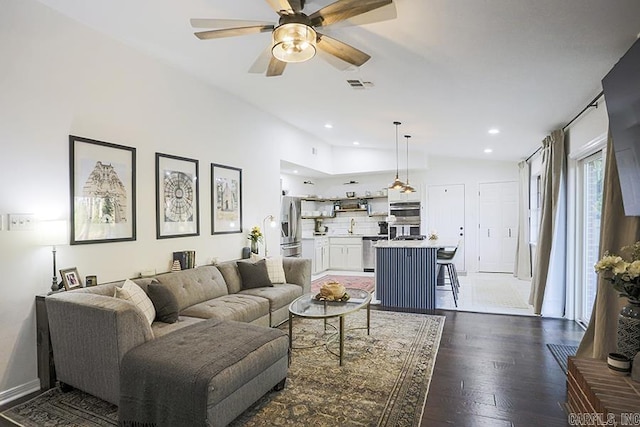living area with visible vents, wood finished floors, ceiling fan, recessed lighting, and vaulted ceiling