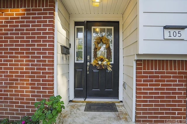 property entrance with brick siding