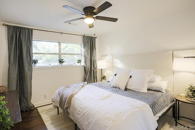 bedroom featuring baseboards, a ceiling fan, and wood finished floors
