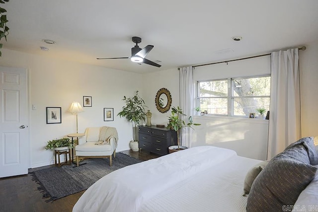 bedroom with baseboards, ceiling fan, and wood finished floors