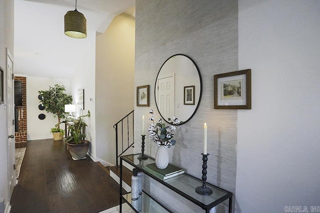 hallway featuring stairway, high vaulted ceiling, baseboards, and hardwood / wood-style floors