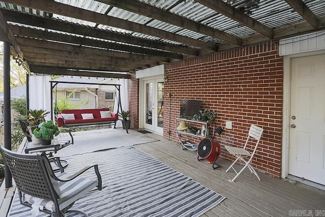 wooden deck with french doors and a pergola