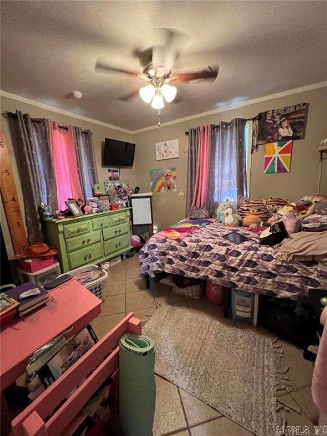 tiled bedroom featuring a ceiling fan, a textured ceiling, and ornamental molding