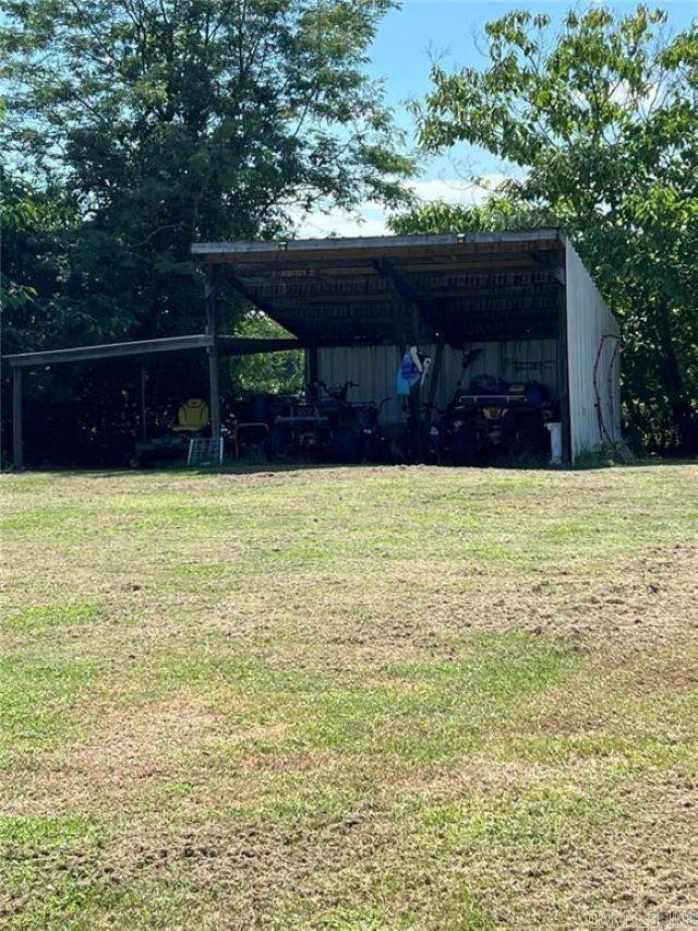 view of yard with a pole building, an outdoor structure, and a detached carport