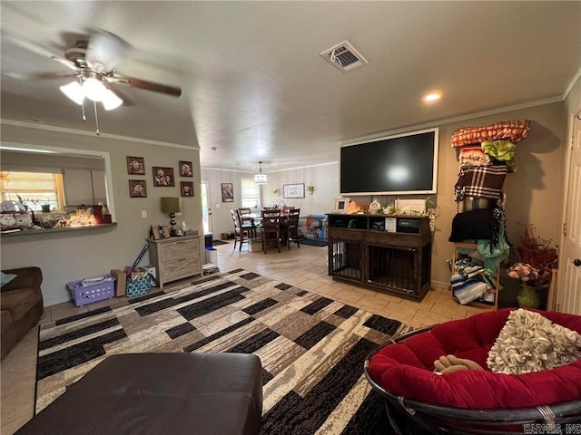 living room with ceiling fan, light tile patterned floors, a wealth of natural light, visible vents, and ornamental molding