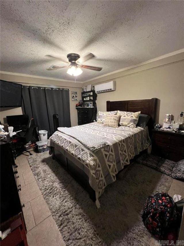bedroom featuring a textured ceiling, a wall mounted AC, ornamental molding, and ceiling fan