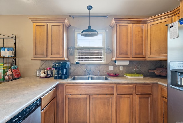 kitchen featuring light countertops, a sink, backsplash, and stainless steel appliances