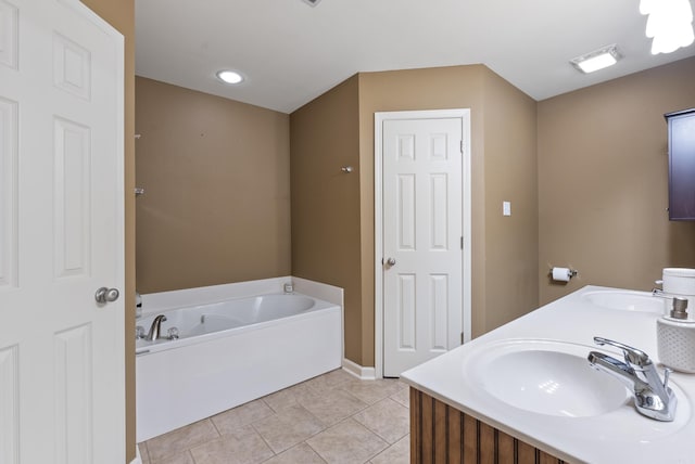 bathroom with a sink, tile patterned floors, baseboards, and a garden tub