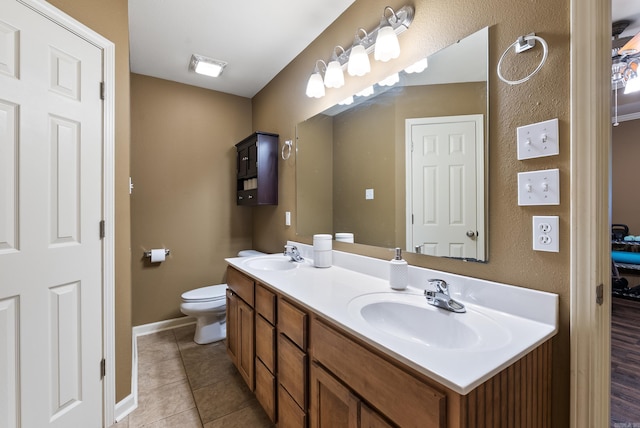 full bath featuring a sink, tile patterned flooring, toilet, and double vanity