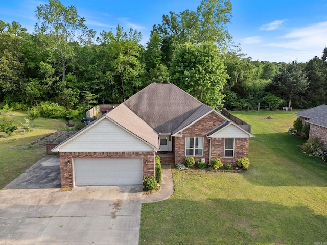 view of front of property featuring a garage, driveway, a front lawn, and brick siding