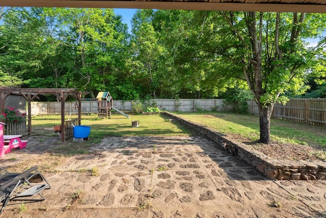 view of yard featuring a fenced backyard and a playground
