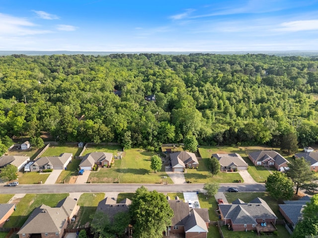 birds eye view of property featuring a view of trees and a residential view