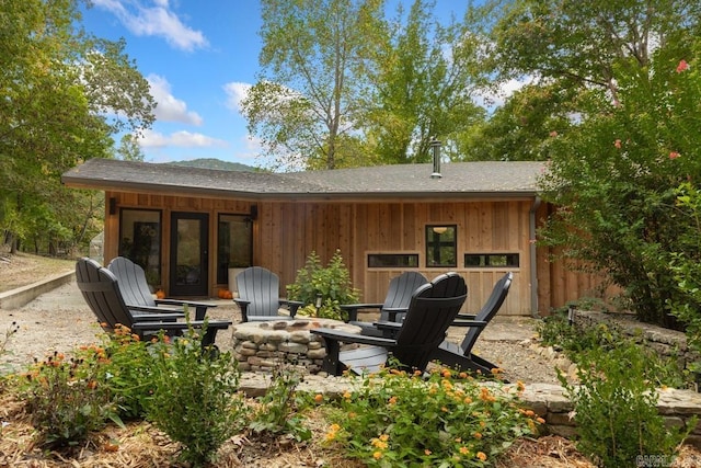 back of property featuring a fire pit