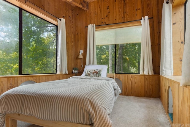 carpeted bedroom with wooden walls