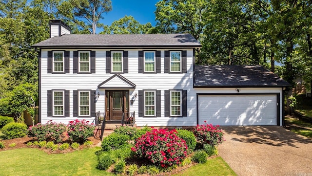 2300 Old Forge Dr, Little Rock, AR 72227 - colonial inspired home featuring roof with shingles, a front lawn, a garage, a chimney, and driveway