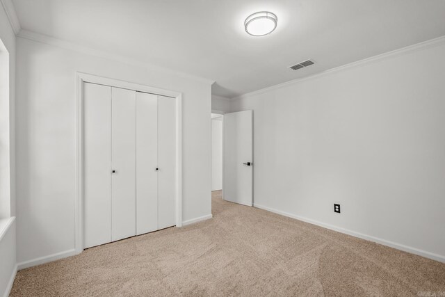 2300 Old Forge Dr, Little Rock, AR 72227 - unfurnished bedroom featuring visible vents, ornamental molding, carpet floors, a closet, and baseboards