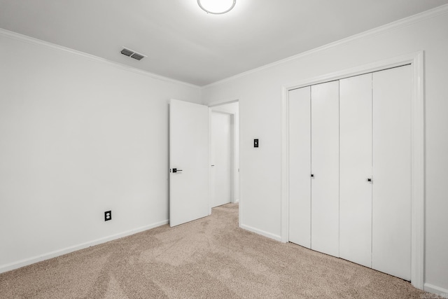 2300 Old Forge Dr, Little Rock, AR 72227 - unfurnished bedroom with visible vents, ornamental molding, a closet, baseboards, and carpet flooring