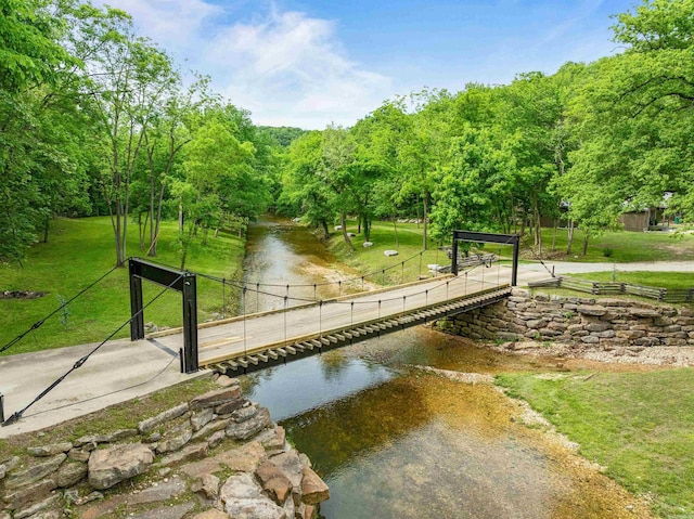 view of home's community featuring a yard and a water view