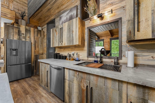 kitchen with light countertops, a sink, wooden ceiling, and stainless steel appliances