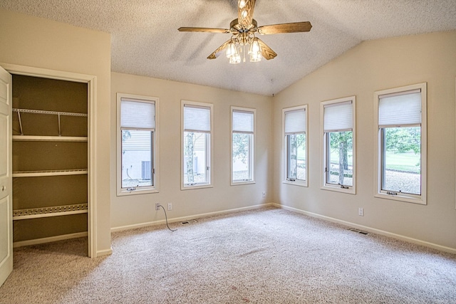 unfurnished room featuring a ceiling fan, a textured ceiling, visible vents, and carpet