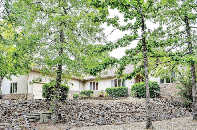 view of front of home with an attached garage and brick siding