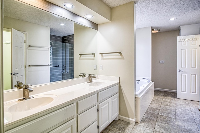 bathroom with double vanity, baseboards, and a sink