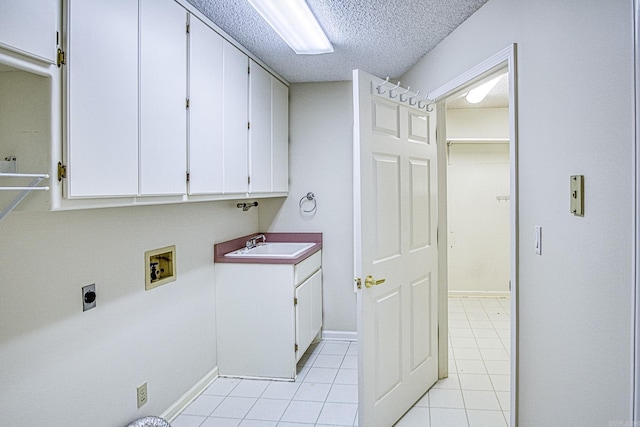 laundry room with cabinet space, light tile patterned flooring, a sink, hookup for a washing machine, and electric dryer hookup