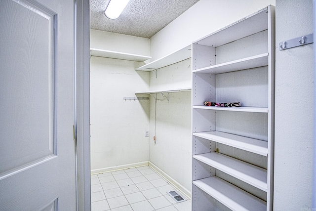 walk in closet with visible vents and light tile patterned floors