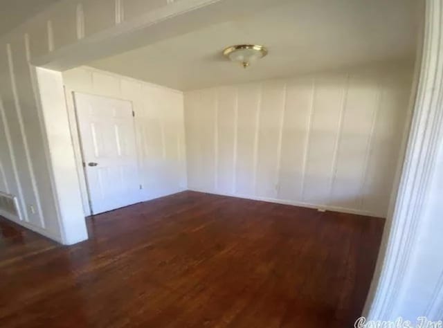 spare room featuring dark wood-type flooring