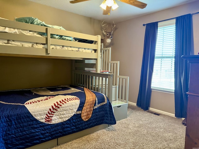 bedroom featuring carpet floors, ceiling fan, visible vents, and multiple windows
