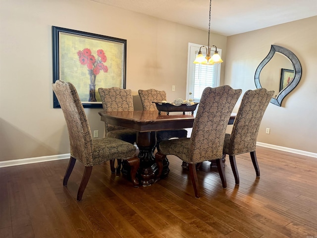 dining room with baseboards, wood-type flooring, and a notable chandelier