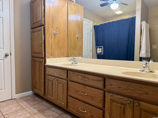 full bath with tile patterned flooring, a sink, ceiling fan, and double vanity