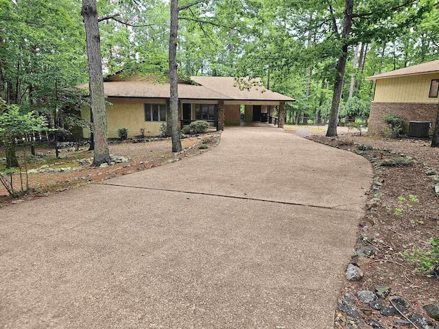 50 Monovar Cir, Hot Springs Village, AR 71909 - view of front of property with concrete driveway, central AC unit, and view of wooded area
