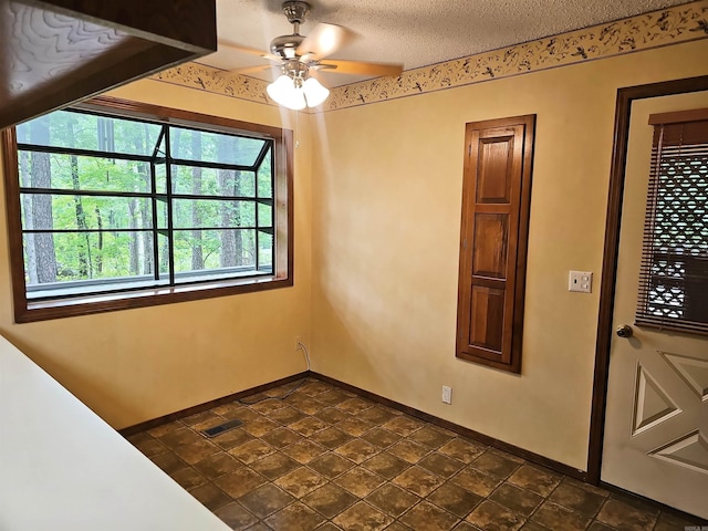 50 Monovar Cir, Hot Springs Village, AR 71909 - spare room featuring a ceiling fan, baseboards, and a textured ceiling