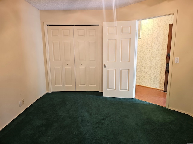 50 Monovar Cir, Hot Springs Village, AR 71909 - unfurnished bedroom featuring dark carpet, a closet, and a textured ceiling