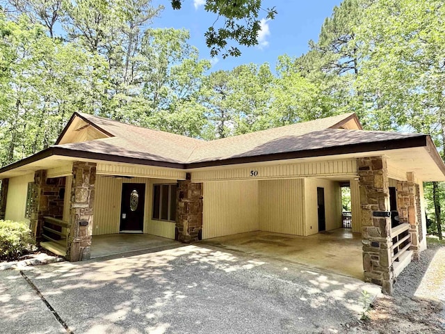 50 Monovar Cir, Hot Springs Village, AR 71909 - view of front of property with stone siding, a shingled roof, a carport, and driveway