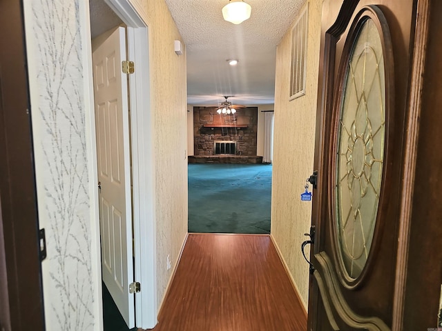 50 Monovar Cir, Hot Springs Village, AR 71909 - corridor with a textured ceiling, a textured wall, baseboards, and dark wood-style floors