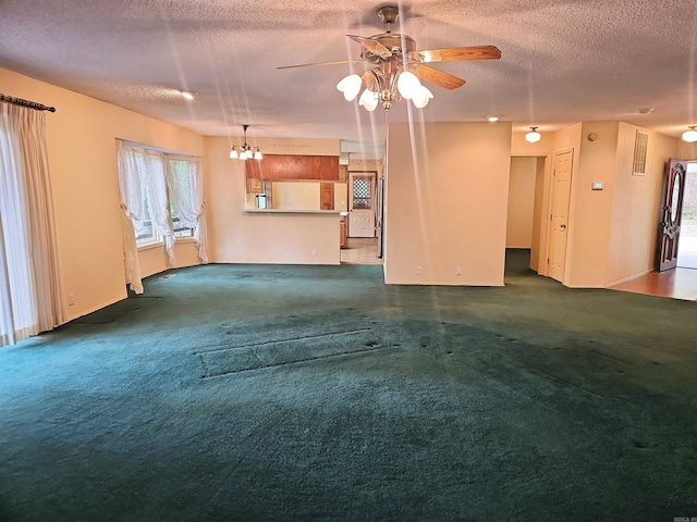 50 Monovar Cir, Hot Springs Village, AR 71909 - unfurnished living room featuring a ceiling fan, a textured ceiling, carpet, baseboards, and a chandelier