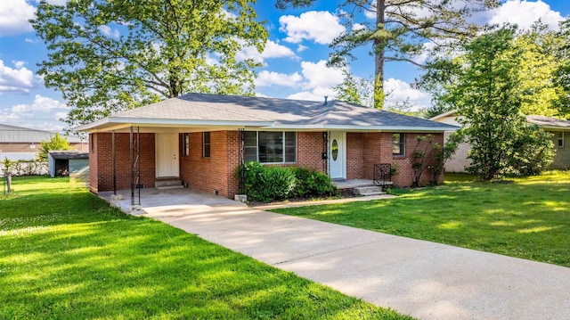 ranch-style house with a carport, a front yard, driveway, and brick siding
