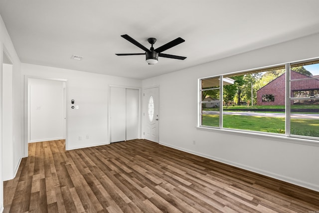 unfurnished living room featuring baseboards, a healthy amount of sunlight, and wood finished floors