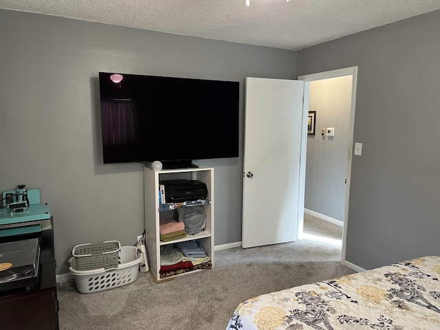 carpeted bedroom featuring baseboards and a textured ceiling