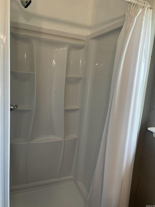 bathroom featuring a shower stall