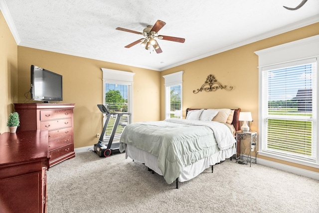 bedroom featuring baseboards, ornamental molding, a ceiling fan, and carpet floors