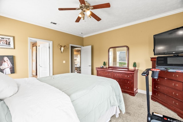 bedroom featuring visible vents, crown molding, baseboards, ceiling fan, and light colored carpet